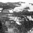 WP&Y Train crossing cantilevered White Pass Railroad bridge. 1907