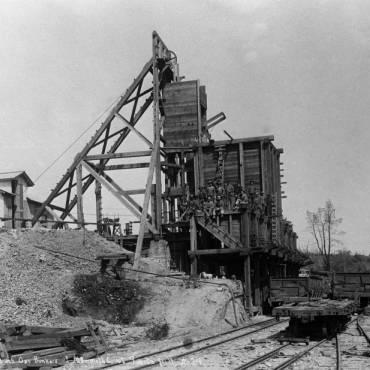 Quartz Hill mine headframe and ore bins with Quartz Hill RR rolling stock in foreground.